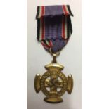 A GERMAN LUFTSCHUTZ BRAVERY CROSS AND RIBBON. Condition: very good