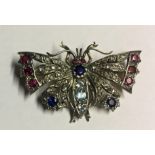 AN EDWARDIAN DIAMOND, RUBY AND SAPPHIRE BUTTERFLY BROOCH. (4.2cm x 3cm)