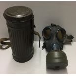 A WORLD WAR II GERMAN GAS MASK AND CANNISTER Numbered '401'. Condition: surface rust