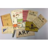 A SELECTION OF ARP (AIR RAID PROTECTION) ITEMS To include two armbands, a whistle and booklets.