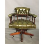 A VICTORIAN DESIGN CAPTAIN'S DESK CHAIR In green leather button back upholstery, raised on swivel