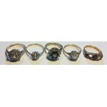 A COLLECTION OF FOUR VINTAGE 9CT GOLD DRESS RINGS Each having a cluster of paste stones in a daisy