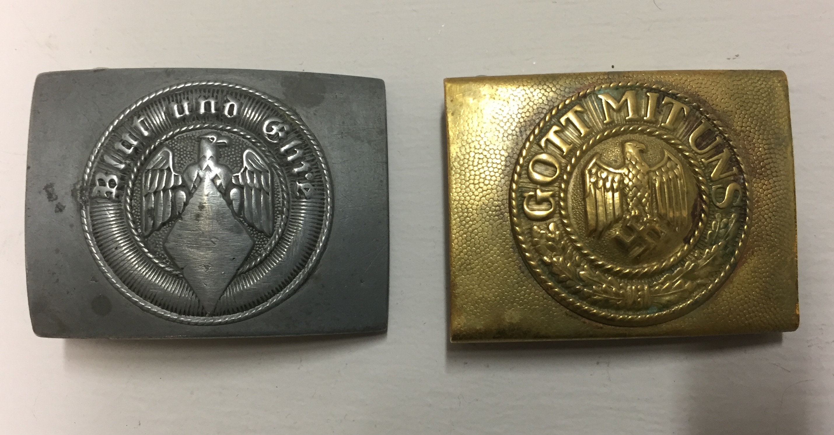 A PAIR OF BUCKLES To include Hitler Youth-Denazified and a brass naval buckle. Condition: naval