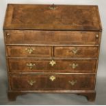AN EARLY 18TH CENTURY WALNUT BUREAU The fall front enclosing a fitted interior above an