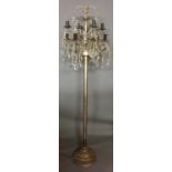 A CONTEMPORARY SILVERED BRASS FLOOR STANDING LAMP Having eight branches hung with faceted pear
