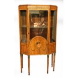 AN EDWARDIAN SATINWOOD DISPLAY CABINET The single door with painted decoration of Cupid, flanked