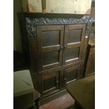 A 17TH CENTURY WELSH OAK CUPBOARD The heavily carved frieze above four panelled doors. (108cm x 76cm
