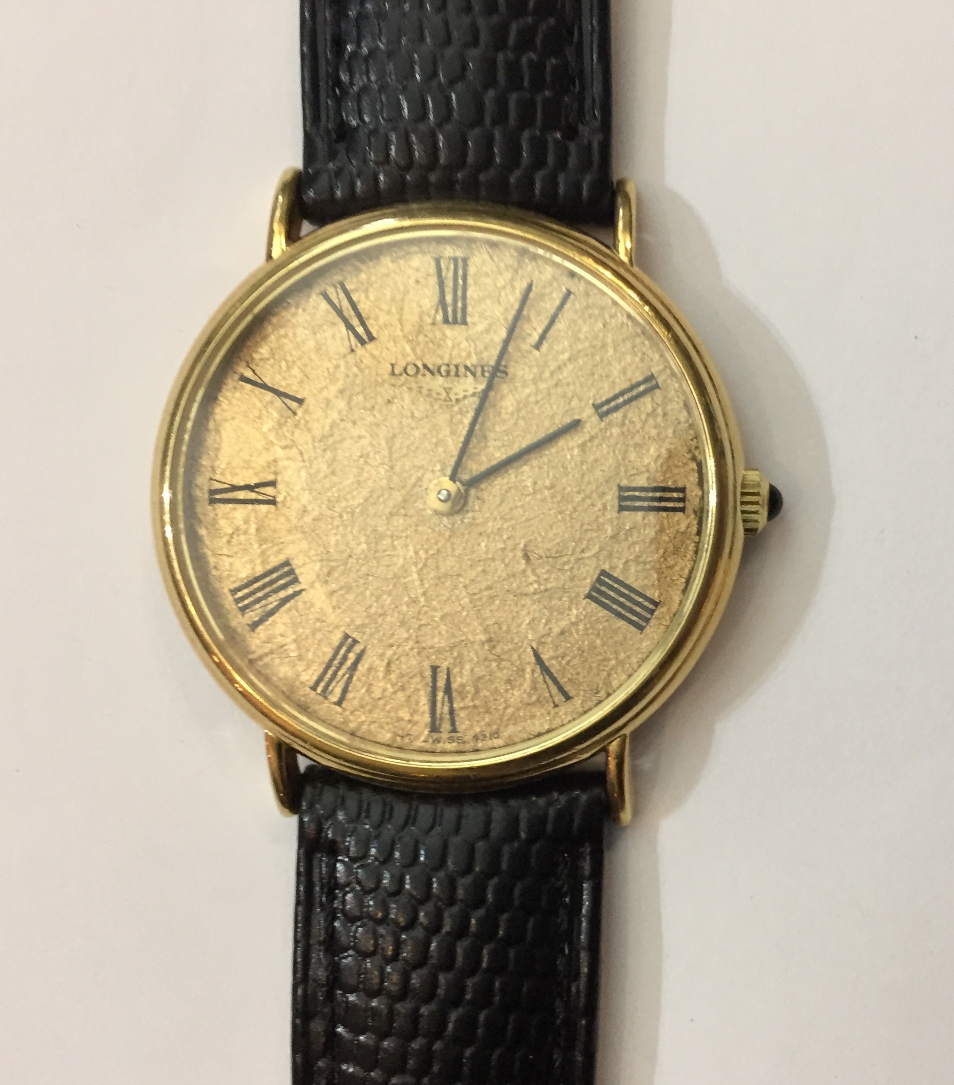 LONGINES, A GENT'S 18CT GOLD SLIM WATCH The yellow textured dial with Roman numeral chapter ring and