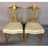 A PAIR OF 19TH CENTURY FRENCH ARMCHAIRS The finely carved wooden frames in a cream painted finish