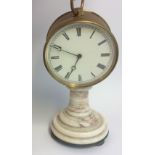 A 19TH CENTURY BRASS AND MARBLE DRUM CLOCK The round dial with Roman numeral markings, raised on a