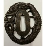 A LATE 20TH CENTURY TSUBA Decorated with a dragon and signed.