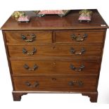 A 19TH CENTURY MAHOGANY CHEST OF DRAWERS Having an arrangement of two short over three graduating