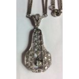 AN ART DECO STYLE 18CT WHITE GOLD AND DIAMOND PENDANT With a single round cut diamond surrounded