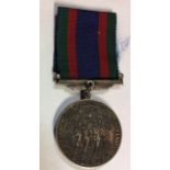 A CANADIAN VOLUNTEER SERVICE MEDAL AND RIBBON. Condition: tarnished but good