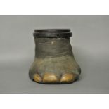 A LATE 19TH/EARLY 20TH CENTURY TAXIDERMY ELEPHANT FOOT CONTAINER. (h 38cm x w 39cm x d 44cm)