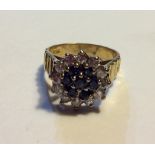 A VINTAGE 18CT GOLD, SAPPHIRE AND DIAMOND RING The daisy style cluster of sapphires surrounded by