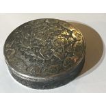 A POSSIBLY PERSIAN CIRCULAR SILVER BOX AND COVER the top with embossed and engraved with birds
