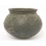 A black earthenware pot,possibly pre-Columbian, of globular form with incised geometric decoration,