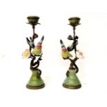 A pair of ceramic and cast metal candlesticks, modelled as love birds on blossom branches, stamped