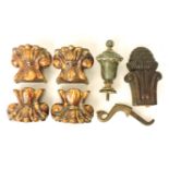 Four treacle glazed earthenware feet (?), together with a carved wood finial, a cast metal finial