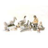 Twelve Copenhagen china ornaments, including ducks, goose, owl, ducklings, nude girl on rock and two