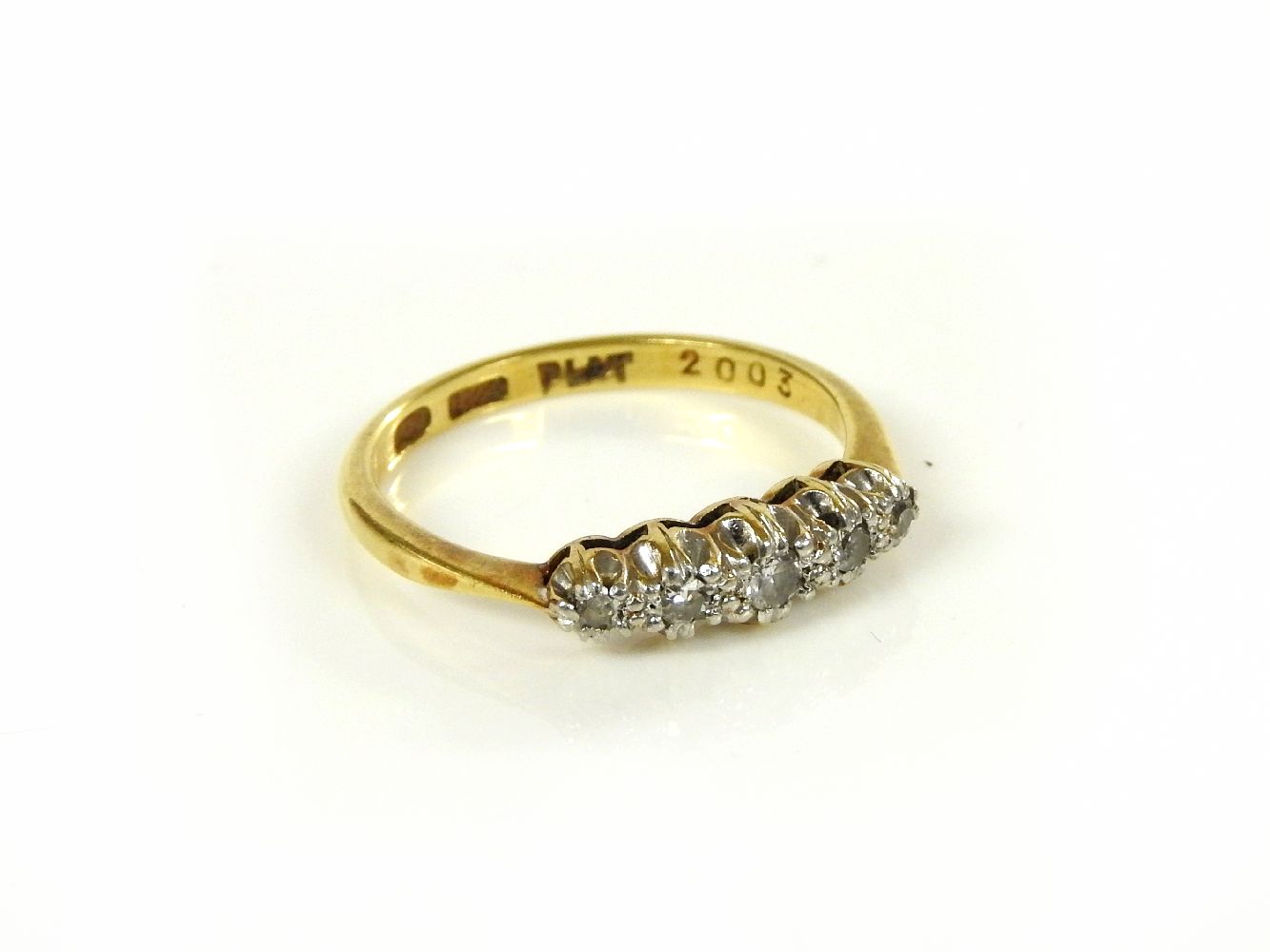 A gold five stone diamond ring, marked 18ct and plat, 2.6g