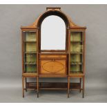 An inlaid mahogany display cabinet, by Maple & Co, the arched central mirror flanked by glazed