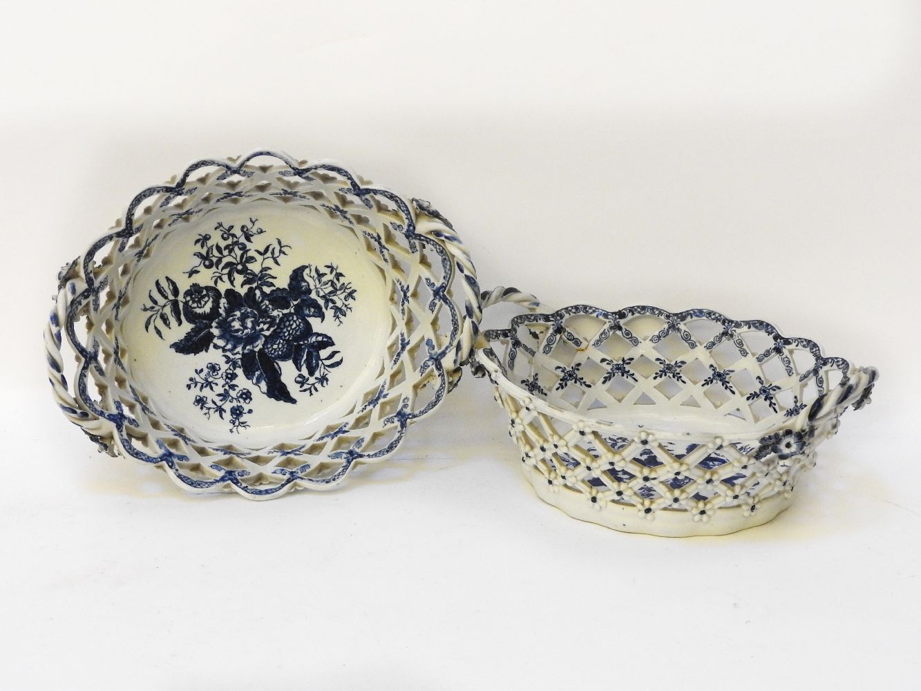 A near pair of 18th century Worcester porcelain basket, pierced lattice sides and twisted handle