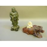 A soapstone figure group of a buffalo and boy, and another figure