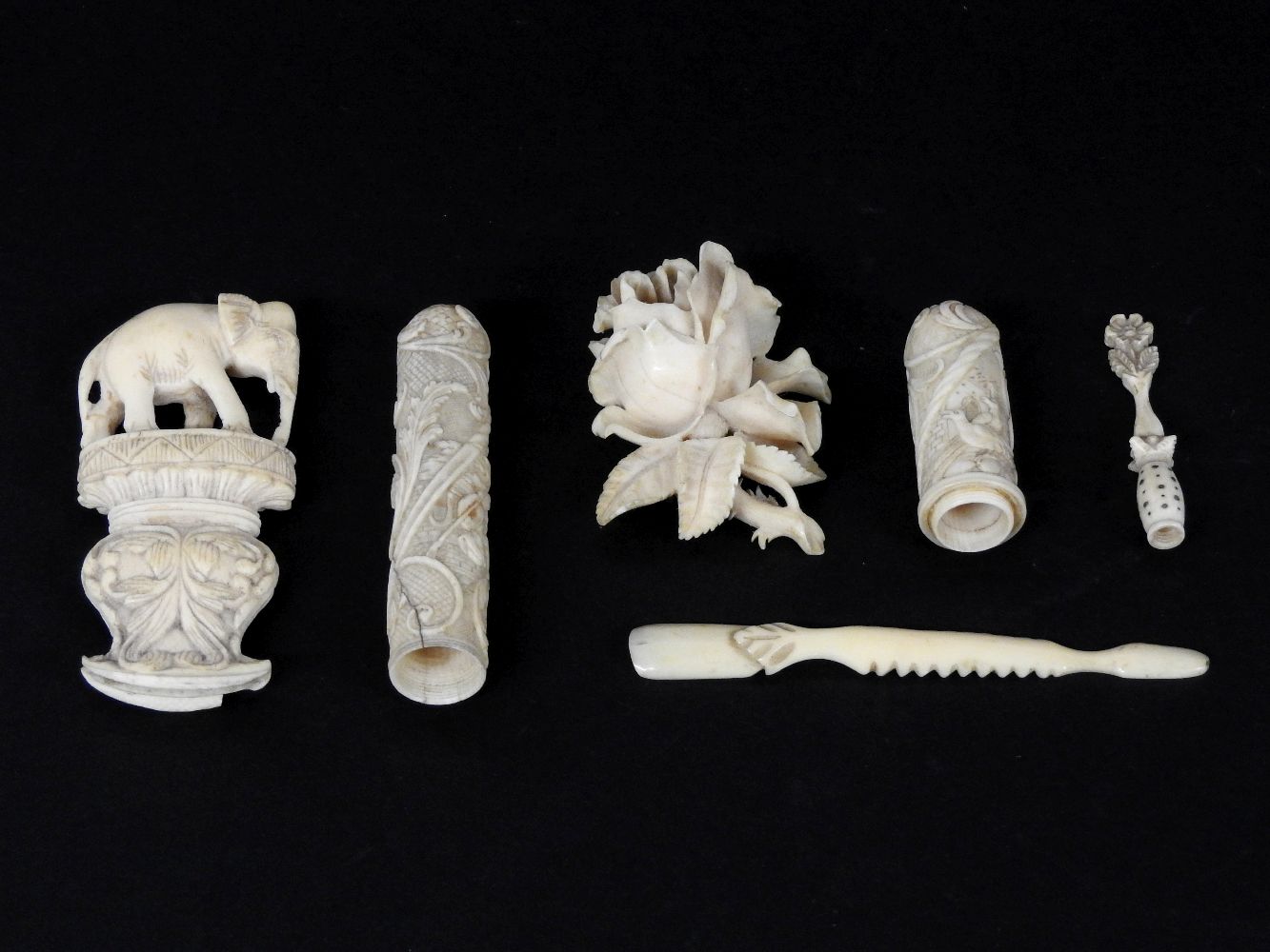 A collection of 19th century ivory items, to include a needle case, a rose brooch, and an elephant