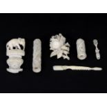 A collection of 19th century ivory items, to include a needle case, a rose brooch, and an elephant