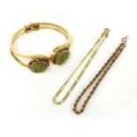 A gold Figaro chain bracelet, marked 585, a 9ct gold rope bracelet, and a costume hinged bangle with