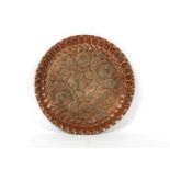 A Persian engraved copper dish, 26cm diameter