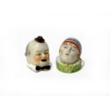 Two German novelty china tape measures, formed as male and female heads, her inscribed 'a present