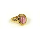 A pair of cabochon pink tourmaline earrings, and a gold cabochon pink tourmaline ring, marked 14k