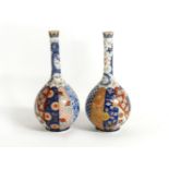 A pair of Meiji period Fukagawa bottle vases, decorated with segmented design and with dragons