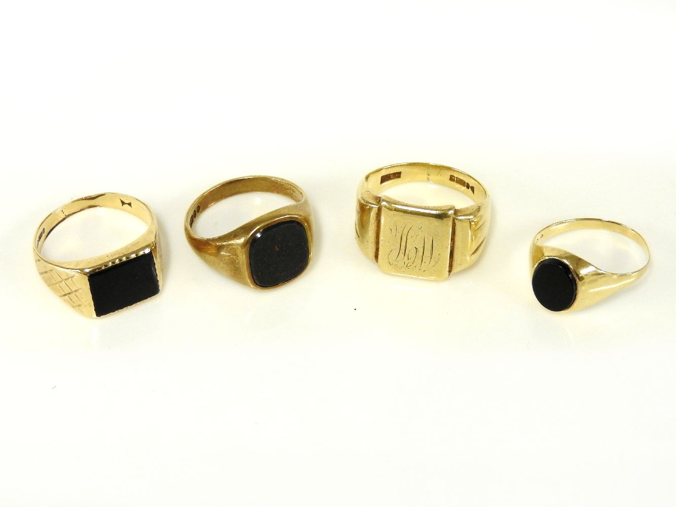 A 9ct gold bloodstone signet ring, a 9ct gold oval onyx signet ring, a 9ct gold rectangular onyx