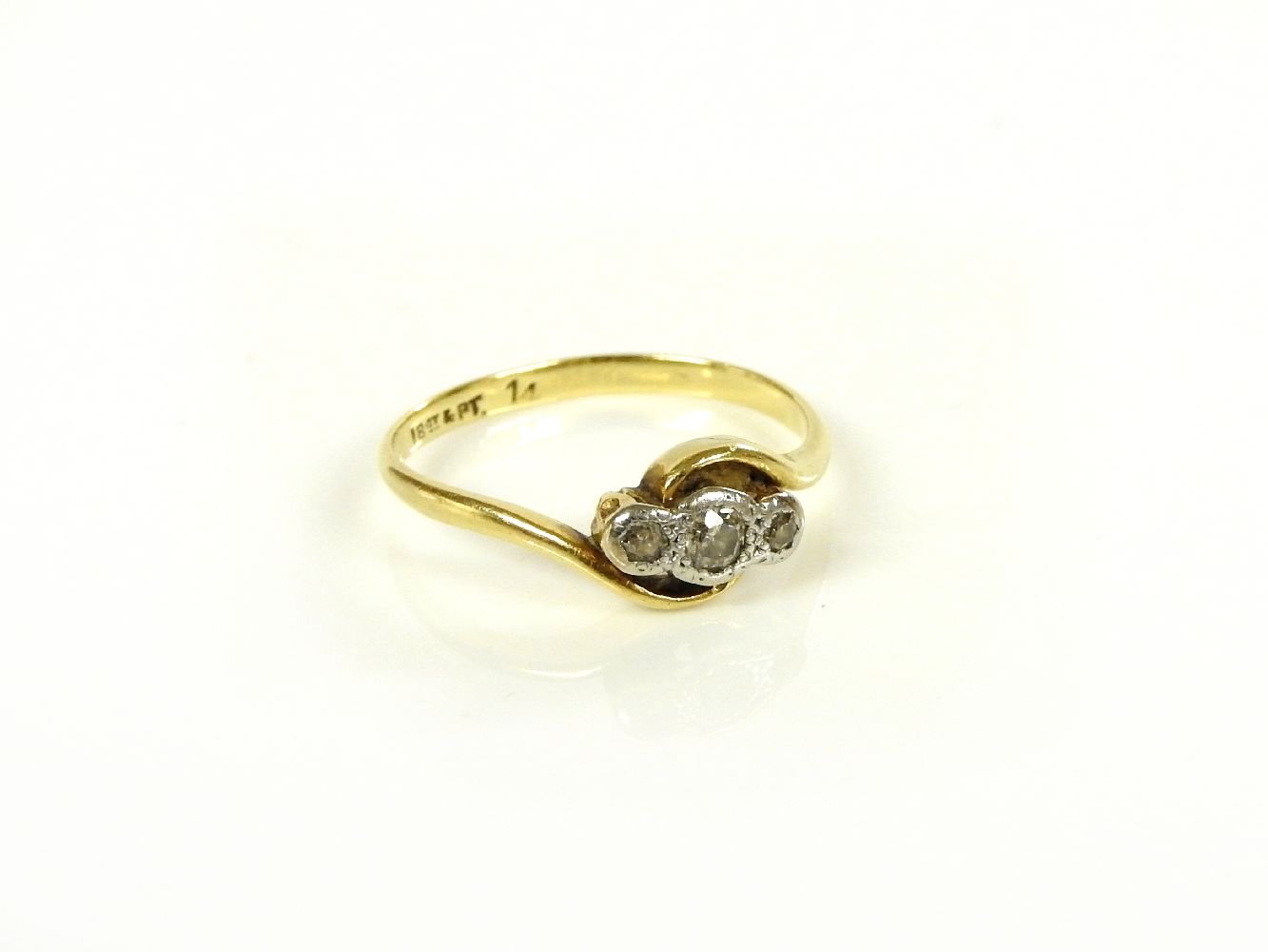 A gold three stone diamond ring, marked 18ct and plat, 1.9g