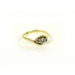 A gold three stone diamond ring, marked 18ct and plat, 1.9g