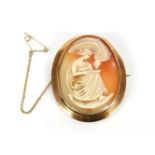 A gold shell cameo brooch, carved with a Grecian lady, marked 9ct