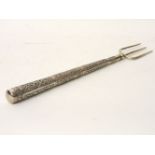 An Indian white metal handled toasting fork