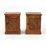 A pair of hardwood bedside cabinets with lattice panelled doors, each 50cm wide