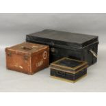 A large black trunk, a deed box, and a small square box