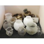 A collection of various oil lamp parts, burners, shades, etc