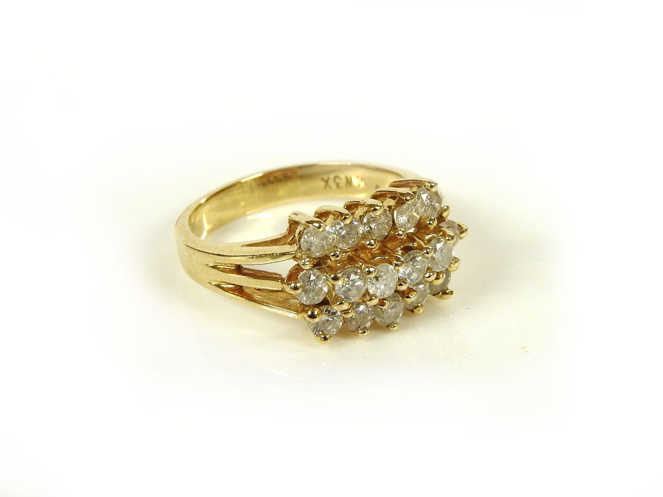 A gold three row diamond cluster ring, marked 14k