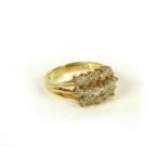 A gold three row diamond cluster ring, marked 14k