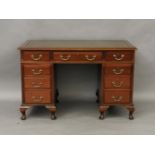 A mahogany pedestal desk of nine drawers, 122cm x 77cm