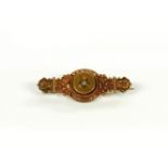 A Victorian 15ct gold Etruscan style bar brooch, set with a single stone diamond