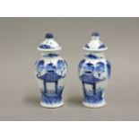 A pair of miniature Chinese blue and white vases and covers, 10cm high