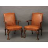 A pair of walnut open armchairs, on carved cabriole legs